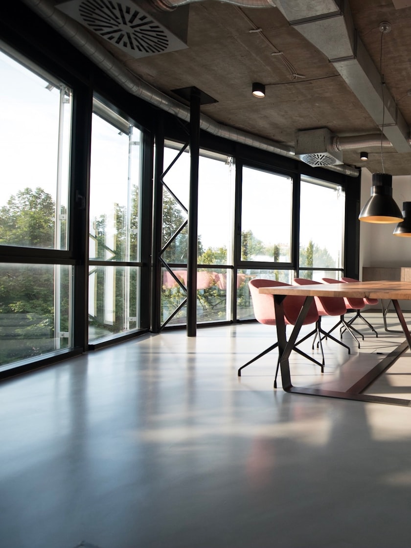 A glazed workspace running down a polished concrete floor.